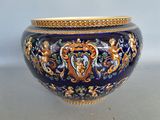 a large blue vase with a gold rim on a table