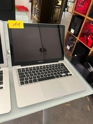 two laptops sitting on a table in a store