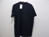 a black t - shirt hanging on a hanger on a wall