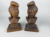 pair of carved wooden busts of a woman and a man