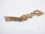 a close up of a gold chain bracelet with a tag on it