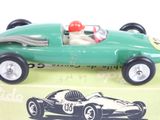 a green toy car with a red helmet on top of it
