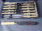 many knives in a case that are sitting on a table