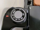 a close up of a camera on a table next to a laptop