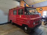 a red fire truck that is parked in a garage