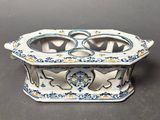 a small blue and white dish on a table