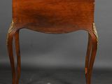 a small wooden table with a drawer on top of it