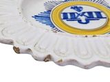 a white plate with a blue and yellow emblem on it