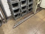 a stack of metal pipes and a bunch of bins