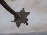 a close up of a metal object with a flower on it