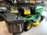 a lawn mower that is sitting in the middle of the room