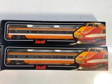two boxed boxes of toy trains sitting on top of a white table