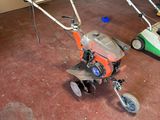 two lawn mowers that are sitting in a garage