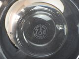 a close up of a glass bowl with a logo on it