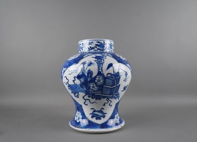 vase bleu et blanc orné d'un bateau sur un fond gris