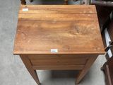 a small wooden table with a drawer on top of it