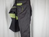 a pair of pants hanging up against a curtain in front of a white curtain