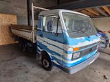 a blue and white truck parked in a garage