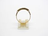 a close up of a gold ring on a white surface