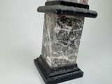 a statue of a man with a top hat on it ' s head