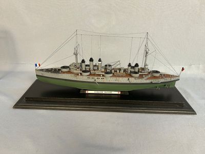 a model of a large ship on a wooden base