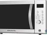 une photo d'un four à micro-ondes argenté avec une porte noire