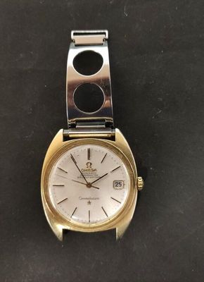 a close up of a watch on a black surface