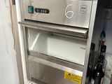 an image of a kitchen with a refrigerator and wine bottles