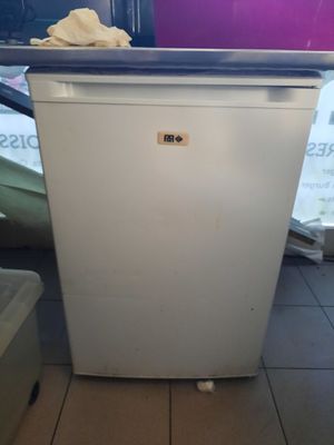 an image of a small white refrigerator in a room