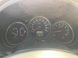 a close up of a car dashboard with various gauges