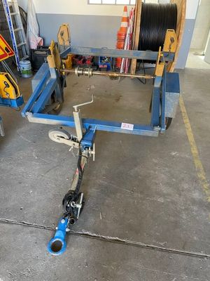 a blue cart with a hose on it in a garage