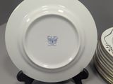 three white plates with blue and white designs on them on a table