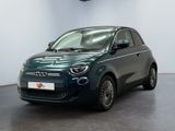 the small car is parked in a large room with white walls