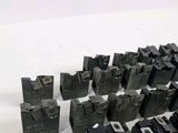 many pieces of metal that are sitting on a white surface