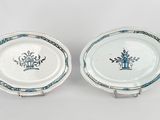 pair of blue and white plates with flowers on them on a white surface