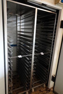 an image of a metal rack with trays of food