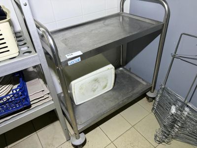 a metal cart that is sitting in the corner of a room