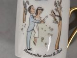 a coffee cup with a picture of a man and a woman on it