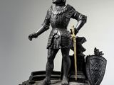 a statue of a man with a sword and shield on top of a clock