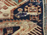 a close up of a blue and red rug with a design on it
