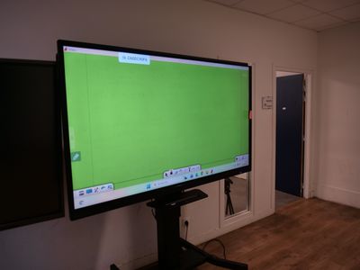 a large flat screen tv sitting on a stand in a room