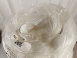 a bag of white yarn wrapped in plastic on top of a table