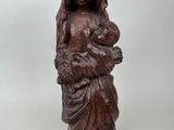 wooden statue of a woman holding a baby in her arms