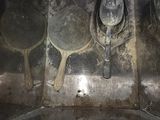 a metal pan with a spoon and a spoon rest on it