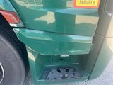 a close up of the front bumper of a green truck