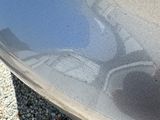 a reflection of a person on the side of a car