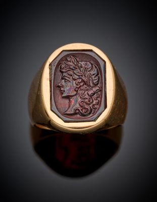 a gold ring with a roman coin in the center