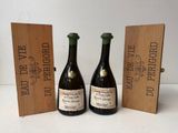 two bottles of wine are sitting next to a wooden box