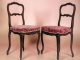 pair of antique chairs with pink upholstered upholstered cushions