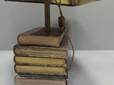 a lamp that is on top of a stack of books